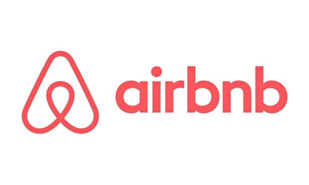 Airbnb-Logo - stilisiert Ein Symbol und ein Titel in Pink