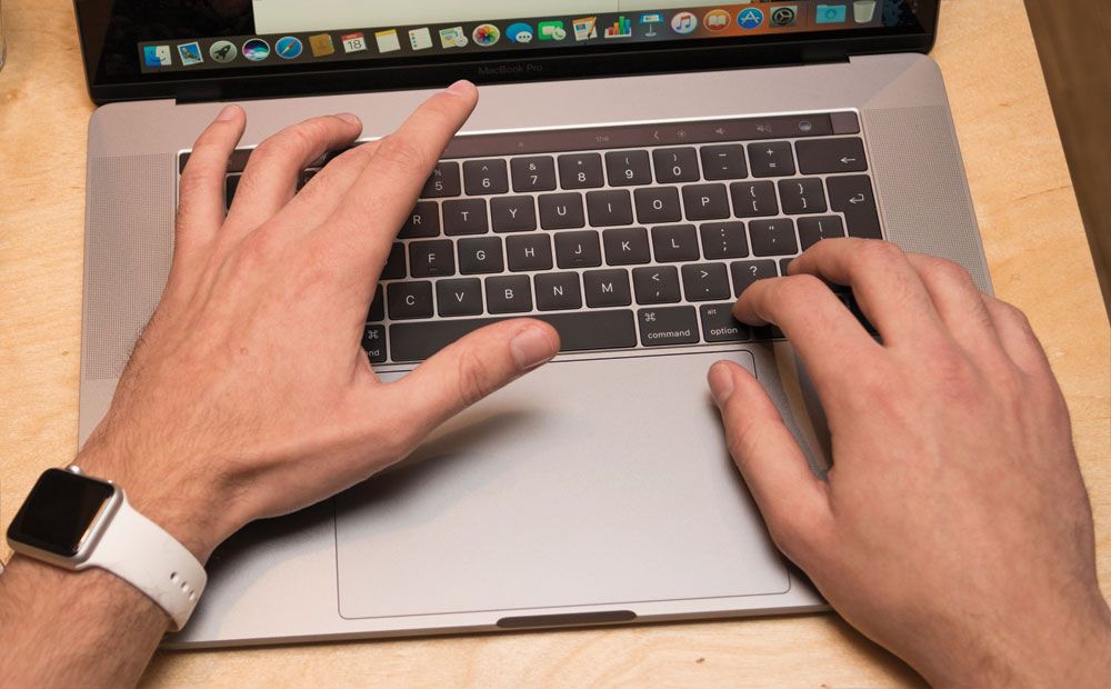Person mit Händen auf Laptop